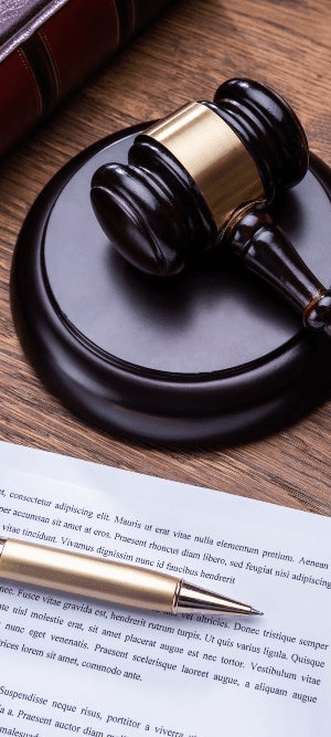 A Governor's pen next to a pardon attorney's gavel.