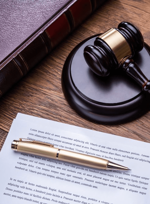 A Governor's pen next to a pardon attorney's gavel.