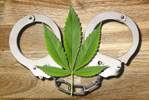 A marijuana leaf on top of a pair of handcuffs to signify how marijuana convictions can differ from others and how Record Eraser can help you receive an expungement.