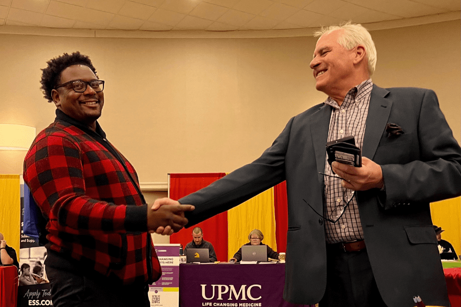 Attorney Walmer handshake with new friend at job fair